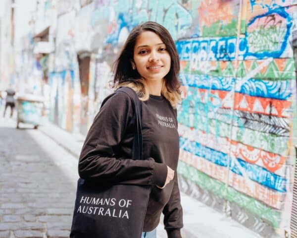 An elegant portrayal of a beautiful woman carrying the Humans of Australia Tote Bag, perfect for urban and everyday use.