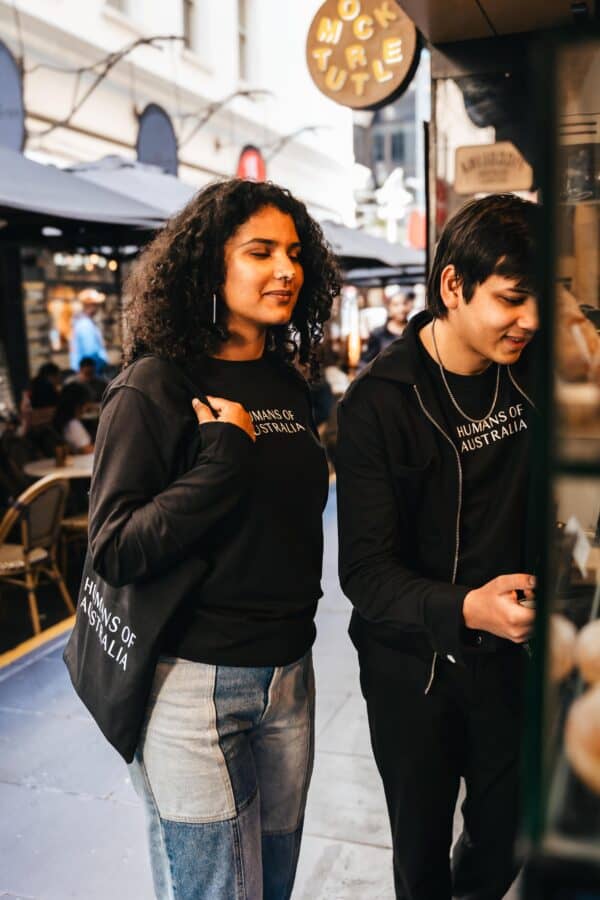 A trendy group embracing the stylish and comfortable Humans of Australia Black Jumpers.