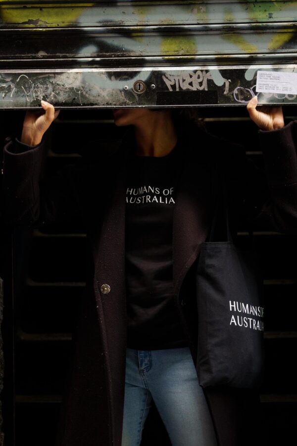 An image of a woman looking stylish and confident in the Humans of Australia Black Jumper.